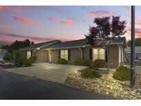 Charming home featuring a landscaped front yard, driveway, and well-maintained exterior under a colorful evening sky at 634 Cypress Ln., North Myrtle Beach, SC 29582