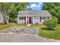 Charming single-story home with red door, red shutters, and small front yard at 6628 Mallard View Point, Myrtle Beach, SC 29588
