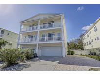 Beautiful three-story home featuring double balconies and a two-car garage, perfect for beach living at 703 37Th Ave. S, North Myrtle Beach, SC 29582