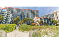 A beautiful multi-story resort view from the beach access path on a sunny day at 7200 N Ocean Blvd. # 1058, Myrtle Beach, SC 29572