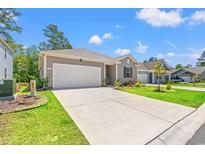 Charming single-story home with a wide driveway, attached garage, and beautifully landscaped front yard at 747 Gryffindor Dr., Longs, SC 29568