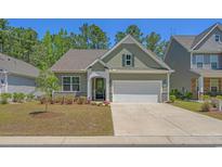 Charming one-story home with a well-manicured lawn, a two-car garage, and beautiful curb appeal at 847 Flowering Branch Ave., Little River, SC 29566