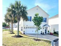 Charming two-story home with palm trees, a two-car garage and lovely curb appeal at 903 Ocean Pines Ct., North Myrtle Beach, SC 29582