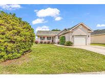 Charming single Gathering home with a well-maintained lawn and attached one car garage at 9616 Sullivan Dr., Murrells Inlet, SC 29576