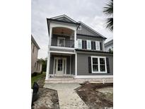 Charming two-story home with gray siding, white trim, and a welcoming front porch at 1348 Rue De Jean Ave., Myrtle Beach, SC 29579