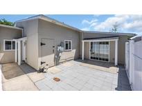 Neutral exterior with a light gray patio, white privacy fence, and sliding glass doors to the interior at 1361 Turkey Ridge Rd. # C, Surfside Beach, SC 29575