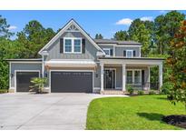Charming two-story home with gray siding, black shutters, two-car garage, and landscaped front yard at 209 Bouquets Green Way, Myrtle Beach, SC 29579