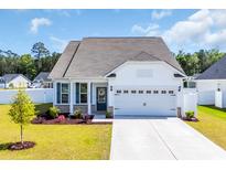 Charming one-story home with a two car garage, manicured lawn, and welcoming curb appeal at 302 Portofino Dr., Myrtle Beach, SC 29579