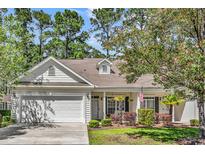 Charming single-story home featuring a manicured lawn, attached garage, and inviting curb appeal at 442 Mahogany Dr. # 101, Murrells Inlet, SC 29576