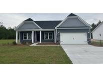 Charming single-Gathering home features a two-car garage, manicured lawn, and classic architectural details at 4762 Huckleberry Ln., Conway, SC 29526