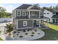 Charming two-story home with a covered porch, balcony, manicured landscaping, and appealing curb appeal at 4862 Mill Pond Rd., Myrtle Beach, SC 29588