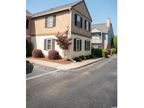 Charming townhome featuring black shutters, manicured landscaping, and a welcoming curb appeal at 501 44Th Ave. N # D 9, Myrtle Beach, SC 29577