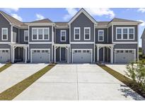 Inviting townhome with gray siding, white trim, and attached one car garage at 5111 Double Eagle Way # 3, North Myrtle Beach, SC 29582