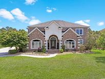 Beautiful two-story brick home with a manicured lawn and arched entryway at 8029 Wacobee Dr., Myrtle Beach, SC 29579