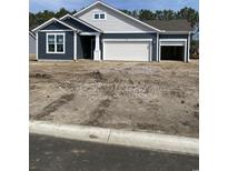 Charming single-story home with blue siding, white trim, two-car garage, and lovely architectural details at 905 Inlet Keys St., Murrells Inlet, SC 29576