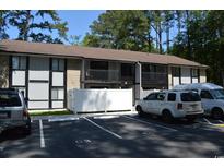 Exterior view of a two-story condo building with parking and balconies surrounded by trees at 950 Forestbrook Rd. # C3, Myrtle Beach, SC 29579