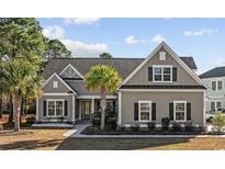Charming single-story home with neutral siding, a palm tree, manicured landscaping, and a cozy, inviting entrance at 1196 Fiddlehead Way, Myrtle Beach, SC 29579