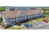 An inviting exterior of a two-story condo with charming balconies and well-maintained landscaping at 138 Butkus Dr. # 2, Myrtle Beach, SC 29588