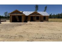 Under-construction single story home featuring an attached garage, and covered entry sitting on a sandy lot at 2186 Mineral Springs Rd., Conway, SC 29527