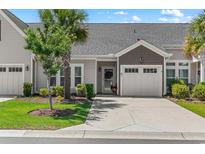 Charming townhome featuring an attached garage, well-maintained lawn, and mature trees for added curb appeal at 232 Je Edward Dr. # 21, Myrtle Beach, SC 29588