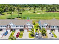 Beautiful aerial view of townhomes overlooking a well-manicured golf course and pond at 260 Connemara Dr. # E, Myrtle Beach, SC 29579