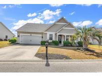 Charming single-story home features a manicured lawn, palm tree, and neutral siding at 3315 Saddlewood Circle, Myrtle Beach, SC 29579