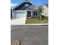 Charming single-story home featuring a two-car garage, manicured lawn, and inviting front entrance at 363 Broughton Dr., Myrtle Beach, SC 29579