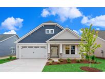 Charming home features a two-car garage, manicured lawn, and a covered front porch at 363 Broughton Dr., Myrtle Beach, SC 29579