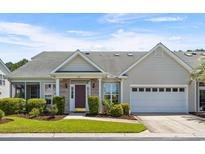 Charming single-story home with a well-manicured lawn, brick accents, and an attached two-car garage at 432 Warrington Way # 432, Murrells Inlet, SC 29576