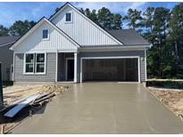 Charming craftsman-style home featuring a newly poured driveway and an attached two-car garage at 440 Sun Colony Blvd., Longs, SC 29568