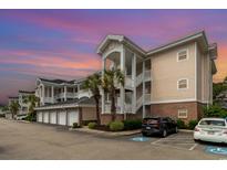 Beautiful condo complex featuring garages, stairs to unit entrances, palm trees, and accessible parking at 4847 Carnation Circle # 201, Myrtle Beach, SC 29577