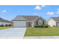 Charming single-story home featuring a well-manicured lawn and a two-car garage at 5107 Capulet Circle, Myrtle Beach, SC 29588