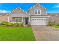 Charming two-story home with a well-manicured lawn and a two-car garage, plus inviting front porch at 5309 Abbey Park Loop, Myrtle Beach, SC 29579