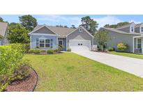 Charming single-story home with a well-manicured lawn and a two-car garage, perfect for suburban living at 5581 Plantersville Pl., Myrtle Beach, SC 29579