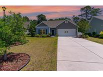 Charming single-story home with a well-maintained lawn and attached two-car garage at 5581 Plantersville Pl., Myrtle Beach, SC 29579