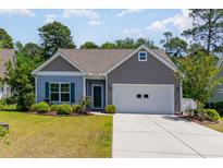 Charming single-story home featuring a well-maintained lawn and a two-car garage at 5581 Plantersville Pl., Myrtle Beach, SC 29579