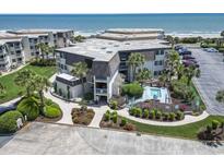 Beautiful beachfront condos with a communal pool, lush landscaping, and convenient parking for a relaxing coastal lifestyle at 5601 N Ocean Blvd. # C-106, Myrtle Beach, SC 29577