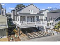 Inviting elevated home with covered parking, spacious deck, and gray siding, perfect for coastal living at 6001-T36 South Kings Hwy., Myrtle Beach, SC 29575