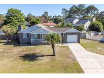 Charming brick home with a well-manicured lawn, a front porch, and a single-car garage at 602 Six Lakes Dr., Myrtle Beach, SC 29588