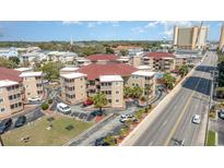 An aerial view shows the condo community, pool, and proximity to the beach at 609 Hillside Dr. S # C-10, North Myrtle Beach, SC 29582