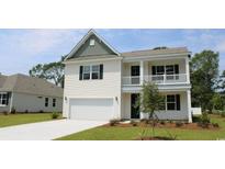 Charming two-story home boasts white siding, a welcoming porch, and an attached garage at 7088 Shooting Star Way, Myrtle Beach, SC 29579