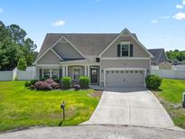 Charming single-Gathering home with a well-maintained lawn and two-car garage and a welcoming front porch at 853 Derbyshire Ct., Conway, SC 29526