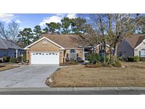 Charming brick home with a well-manicured lawn and attached two-car garage, offering classic curb appeal at 9628 Indigo Creek Blvd., Murrells Inlet, SC 29576