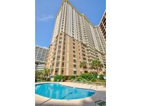 Stunning high-rise building with a beautiful pool and lush landscaping at 9994 Beach Club Dr. # 2403, Myrtle Beach, SC 29572