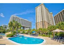 Outdoor pool with palm trees and lounge chairs at 9994 Beach Club Dr. # 2403, Myrtle Beach, SC 29572