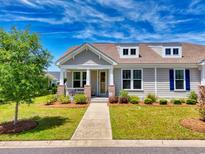 Charming home with a well-manicured front yard and inviting entrance with beautiful columns and landscaping at 1048 Longwood Bluffs Circle, Murrells Inlet, SC 29576