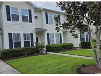 Inviting townhome with well-manicured lawn and lush landscaping, offering great curb appeal at 109 Old Town Way # 4, Myrtle Beach, SC 29588