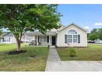 Charming single-story home features a manicured lawn and inviting front porch perfect for relaxing outdoors at 1108 Blue Juniper Ct., Conway, SC 29527