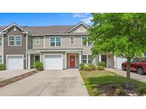 Charming townhomes boast attached garages, nicely landscaped yards, and covered front entryways at 1123 Fairway Ln. # 1123, Conway, SC 29526