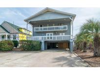 Charming coastal home featuring multi-level balconies and covered parking at 1184 Parker Dr., Pawleys Island, SC 29585